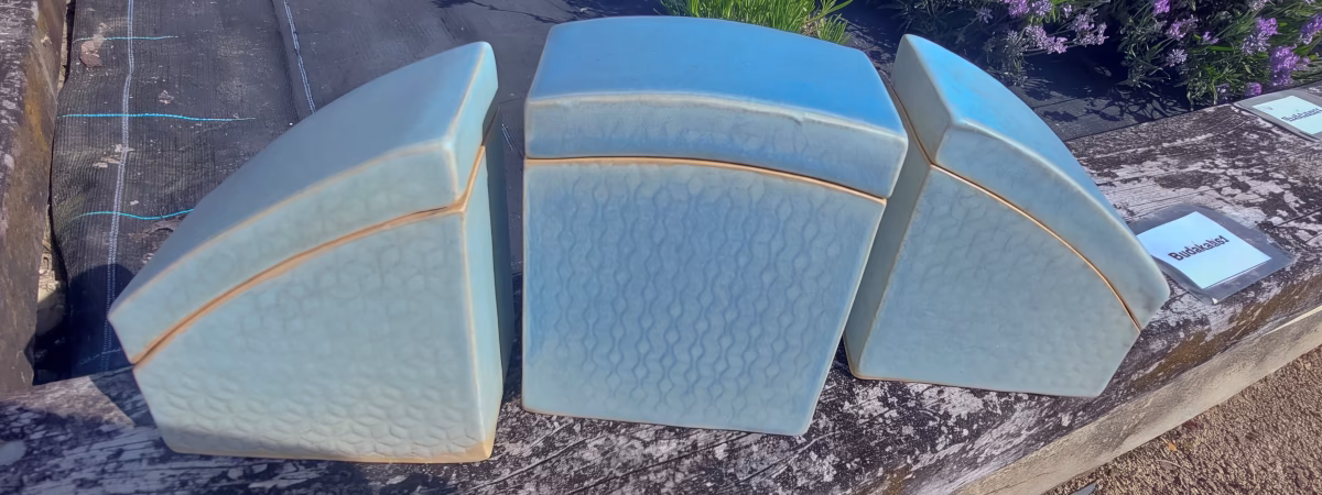 Three pale blue slab-built Fredrock Ceramics boxes with textured geometric surfaces
